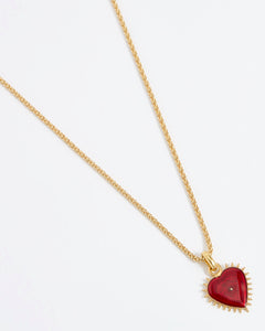 Product shot of Soru Jewellery red heart charm hung from a rope charm chain on white background