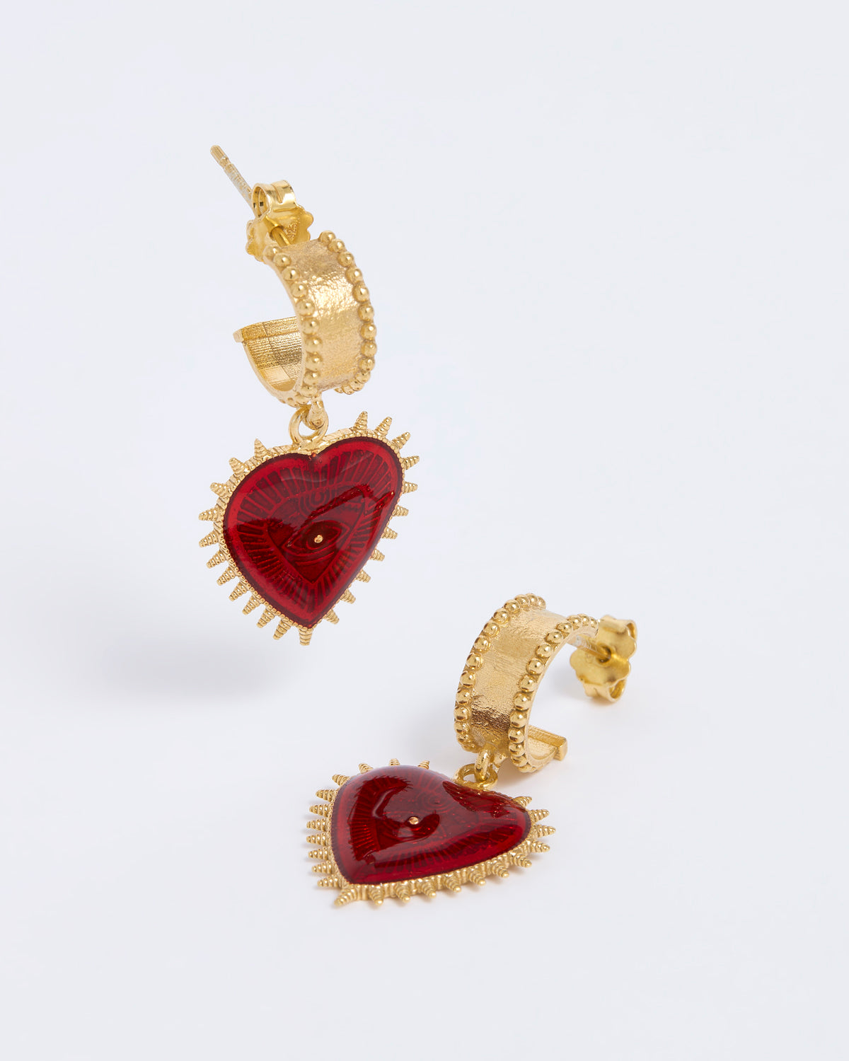 Gold hoop earrings with red heart drop with evil eye