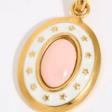 Gold coloured pendant with a pink central stone and star accents on a white background