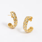 Gold hoop earrings with embedded stones on a white background
