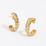 Gold hoop earrings with embedded stones on a white background