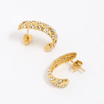 Gold hoop earrings with clear gemstones on a white background