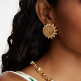 model shot waering the Soru Jewellery crystal embellished coin stud earrings and a gold and crystal necklace