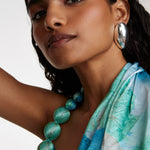 Model shot wearing soru jewellery silver large domed textured earrings