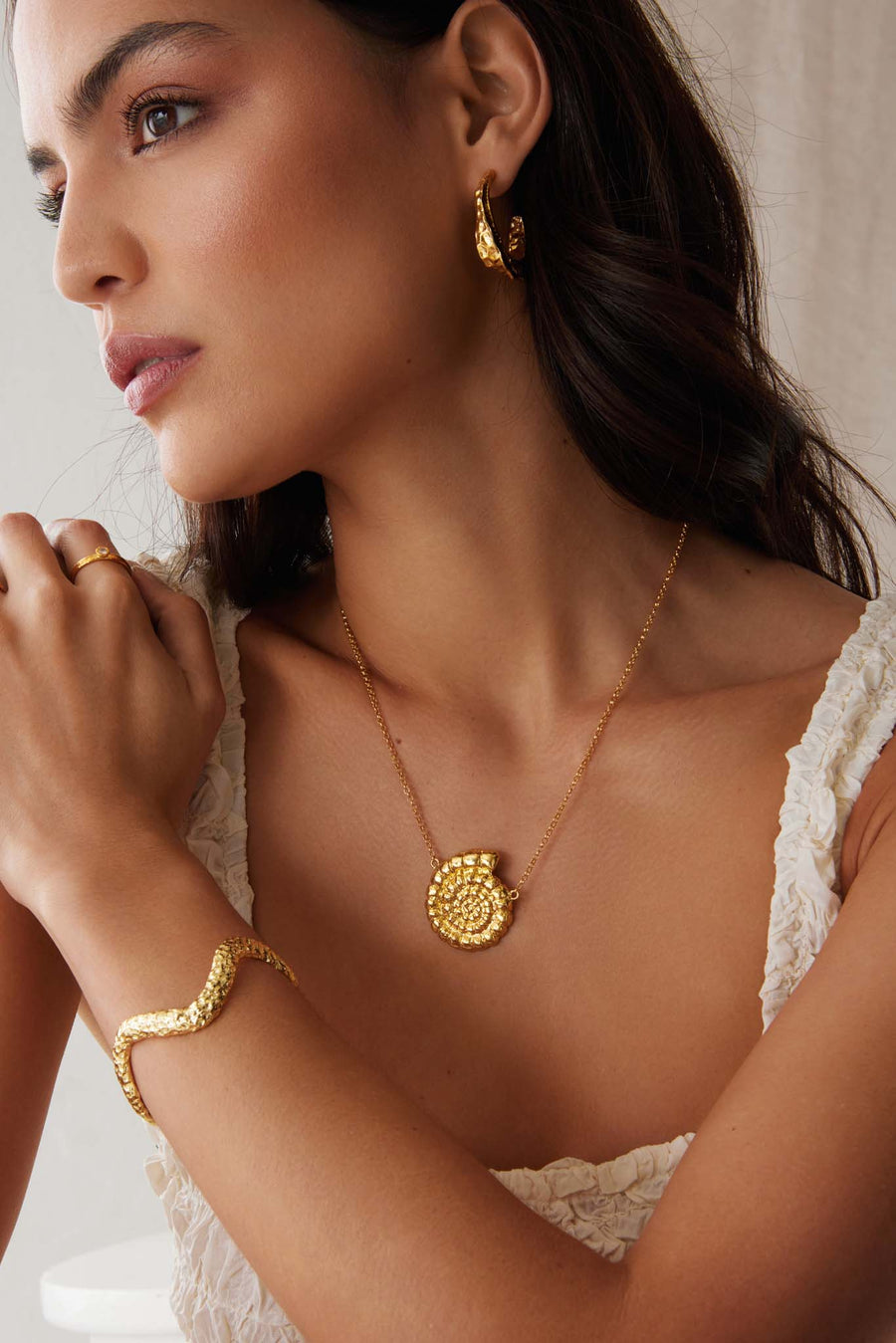 Soru jewellery gold fossil pendant necklace worn on a model 