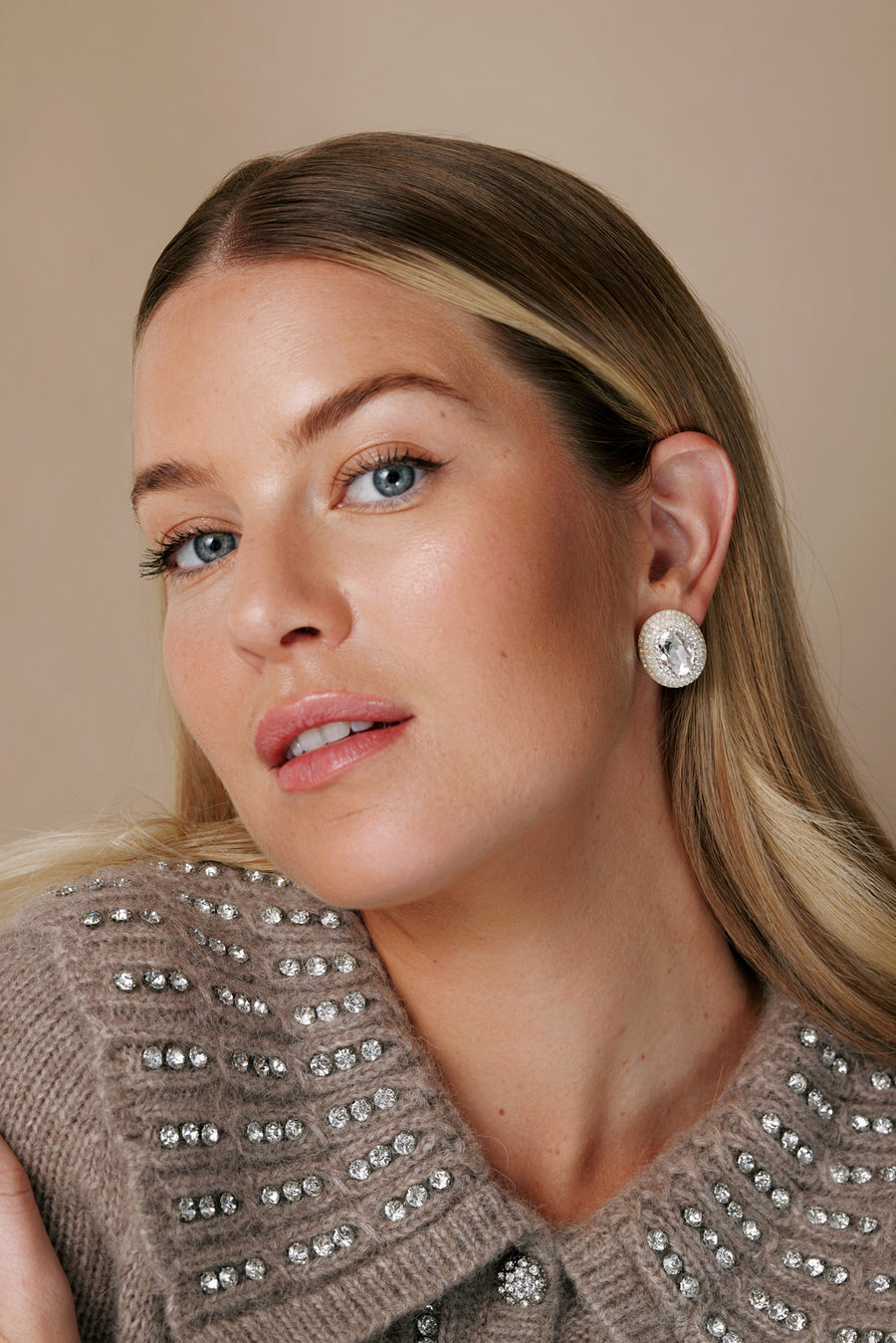 model shot showing the oval crystal stud earrings from the side 