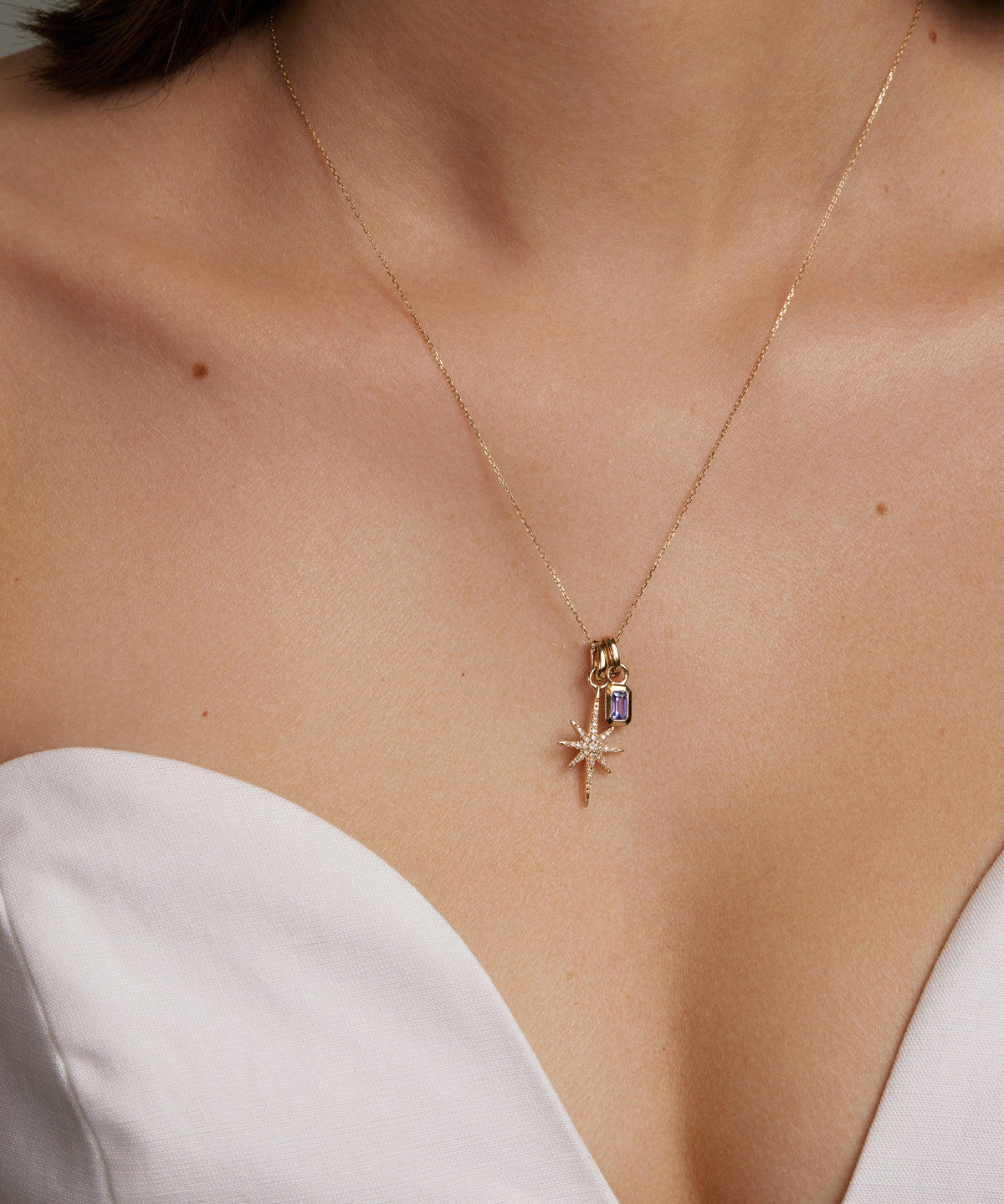 gold and diamond shining star charm, model shot of charm on necklace 