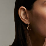 gold and diamond small hoop earring, model shot with moon charm on earring