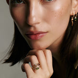 Soru Jewellery garnet and diamond gold ring stacked with other rings on models hand 