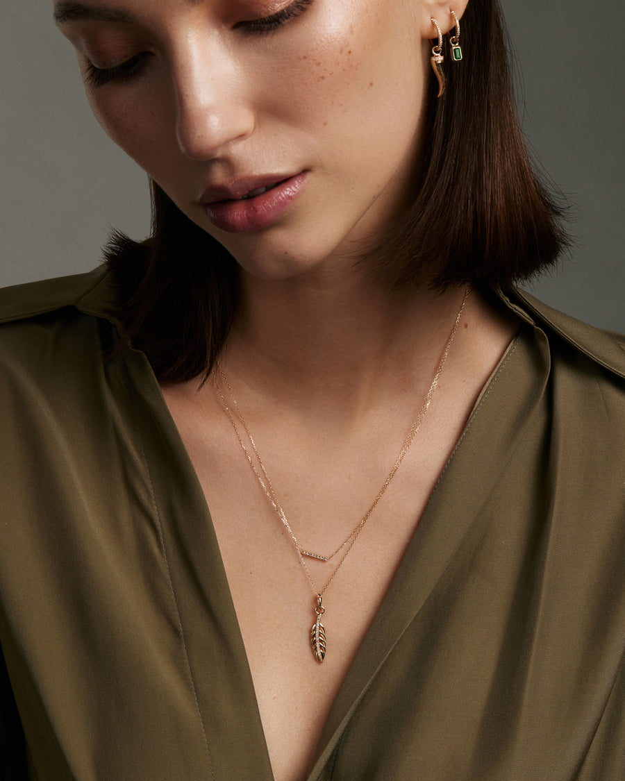 Soru Jewellery diamond bar necklace layered with feather charm on model 