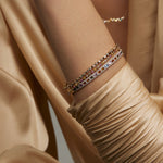 Soru Jewellery diamond tennis bracelet layered with other diamond bracelets and bangles on model 