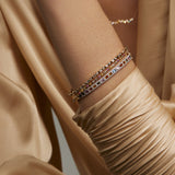 Soru Jewellery diamond tennis bracelet layered with other diamond bracelets and bangles on model 