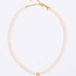 Pearl necklace with gold clasp on a white background