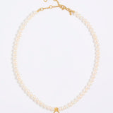 Pearl necklace with gold clasp on a white background