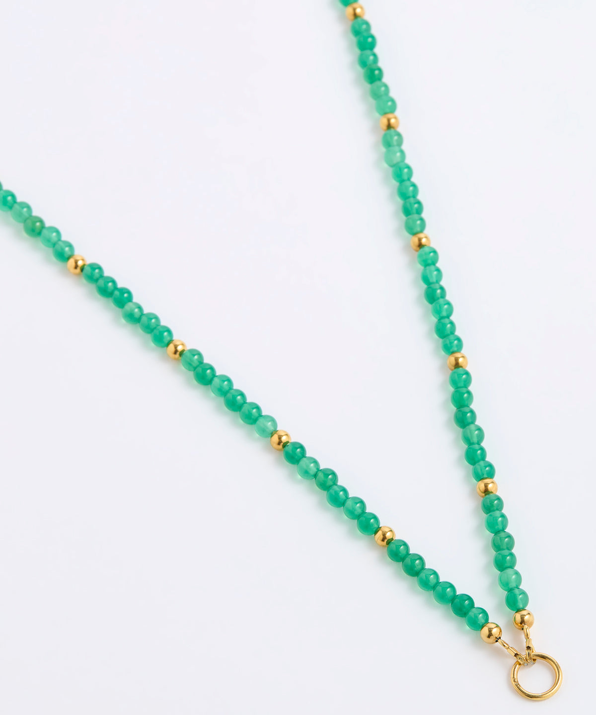 A green beaded necklace featuring round green gemstone beads separated by small gold spacer beads, finished with a gold ring clasp, shown on a plain white background.