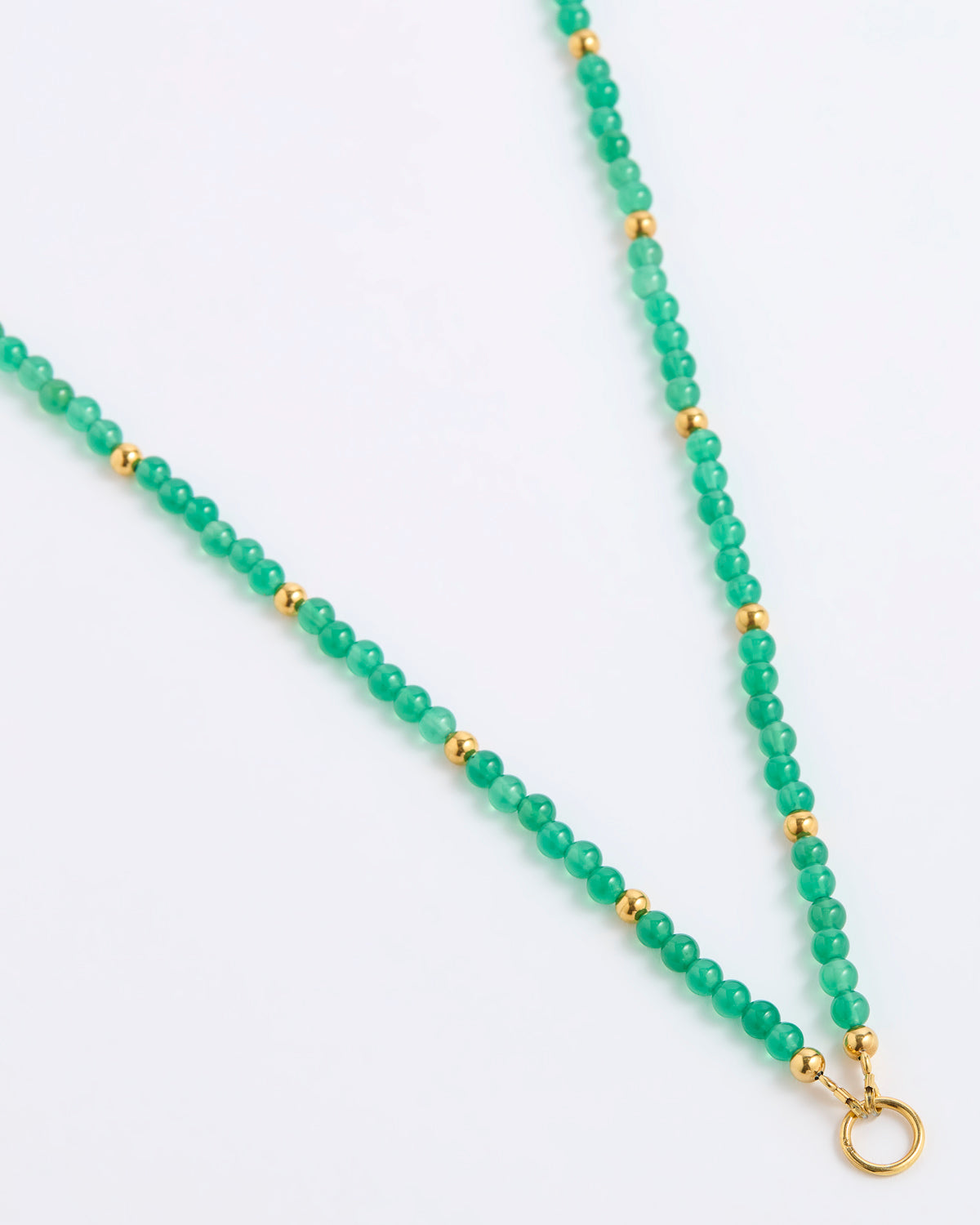 A green beaded necklace featuring round green gemstone beads separated by small gold spacer beads, finished with a gold ring clasp, shown on a plain white background.