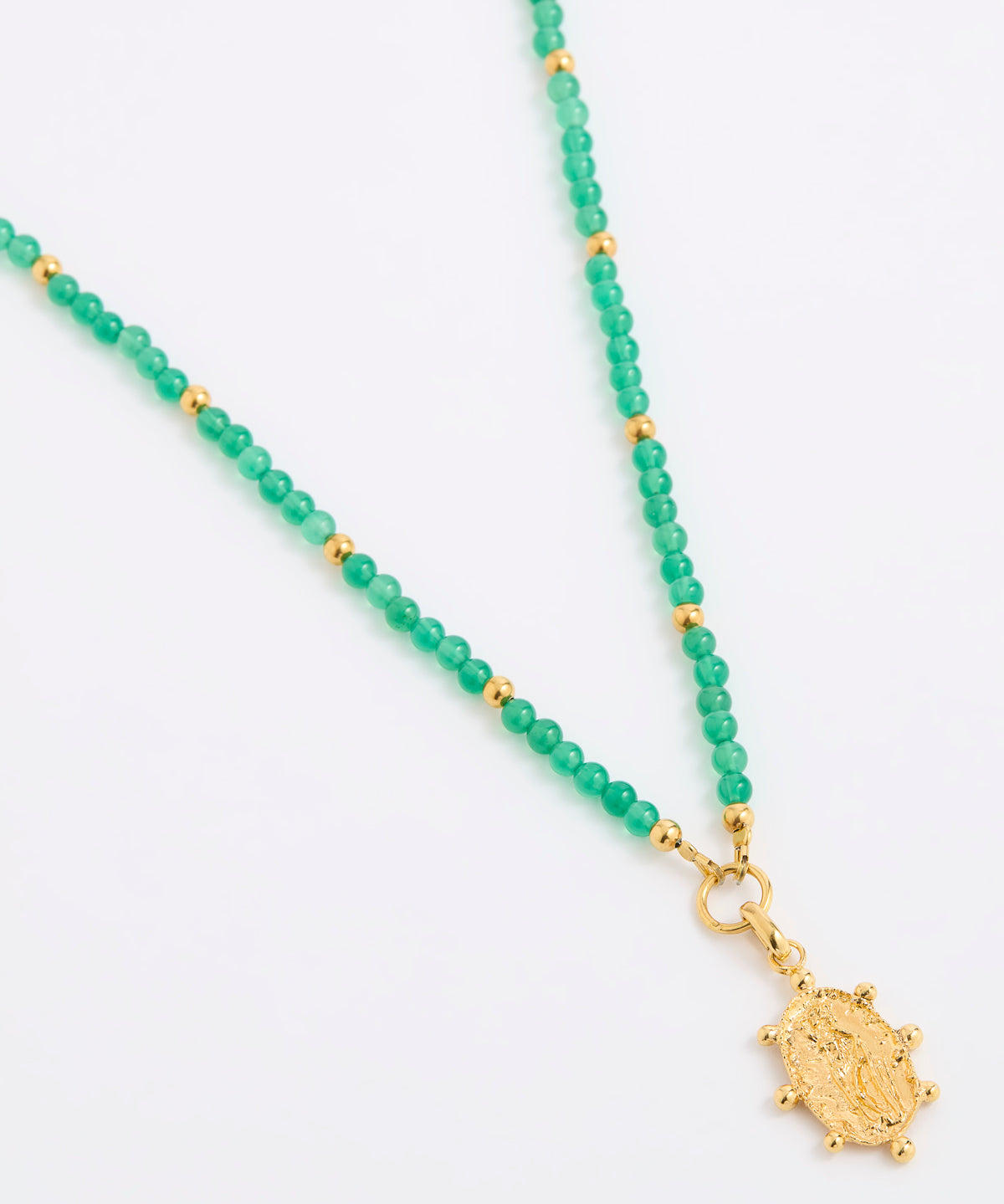 A green beaded necklace featuring small green gemstone beads separated by tiny gold spacer beads, with a textured gold pendant at the end, displayed on a white background.