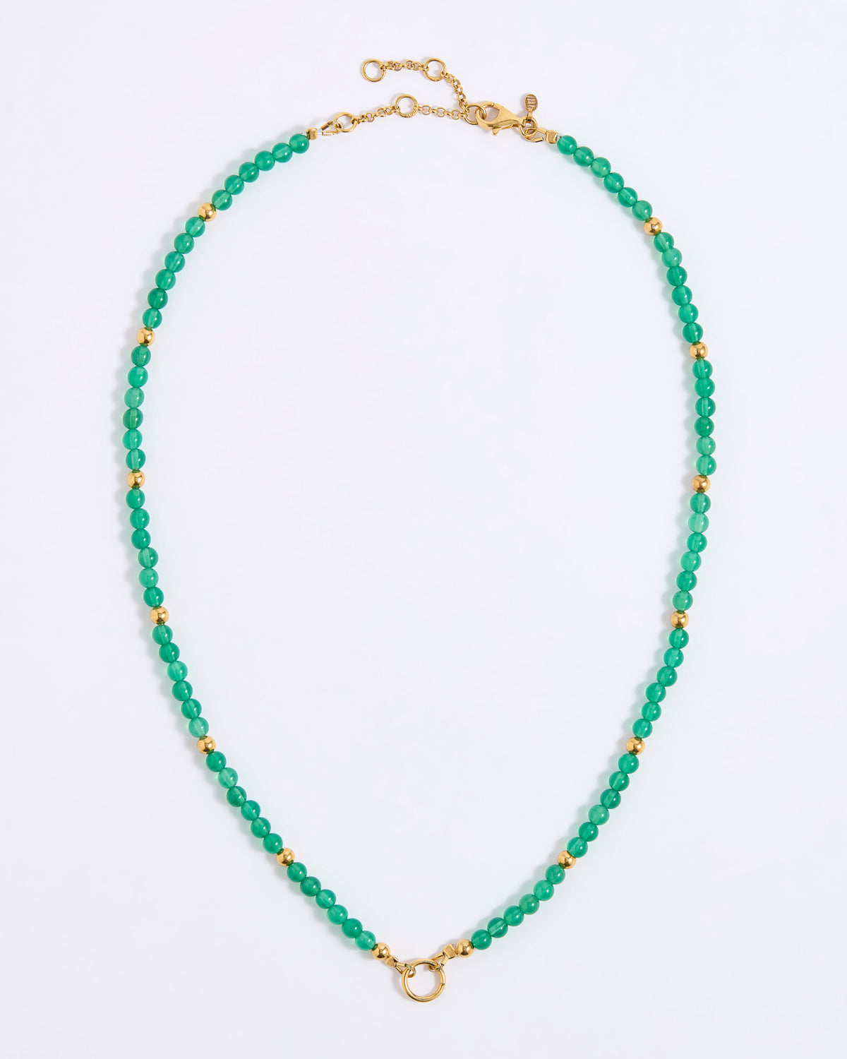 A beaded necklace featuring small, faceted green beads separated by round gold spacer beads, with a gold clasp and extender chain, displayed on a white background.