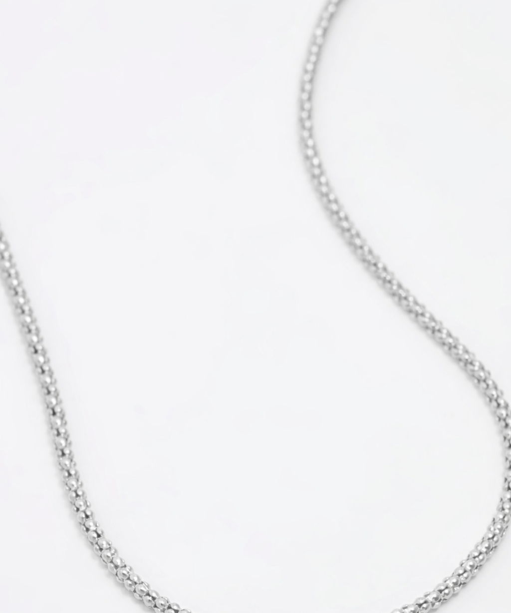 Silver chain necklace on a white background