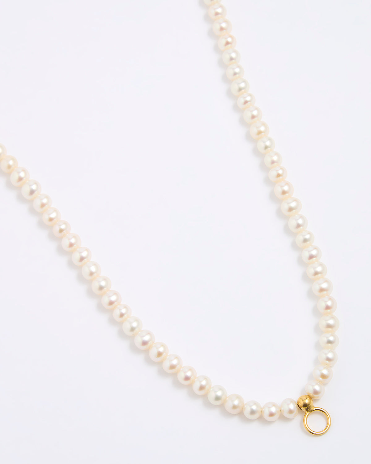 Pearl necklace with a gold clasp on a white background