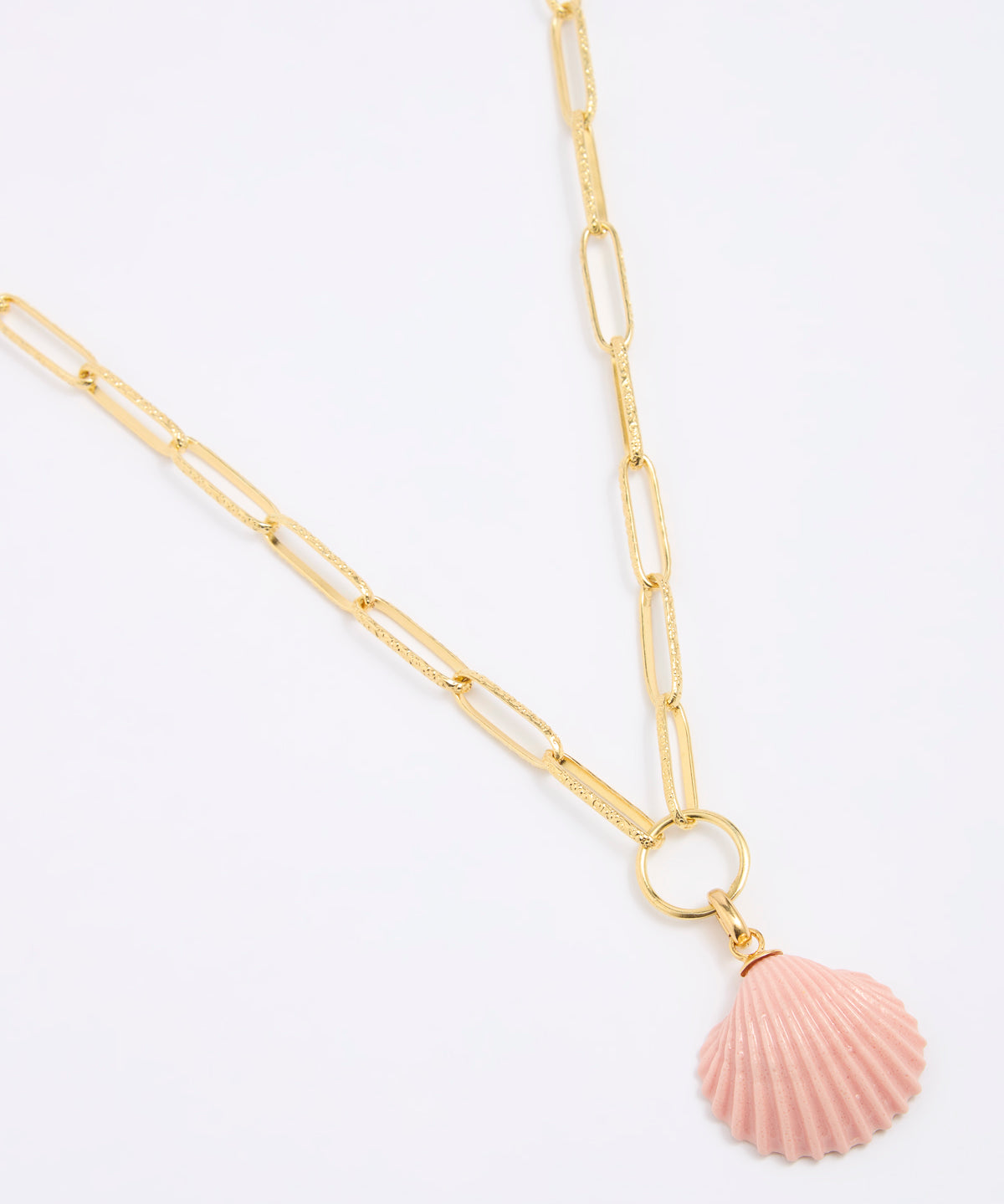 Gold coloured chain necklace with a pink shell pendant on a white background