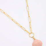 Gold coloured chain necklace with a pink shell pendant on a white background