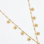 gold chain necklace with nine small dangling stars on white background