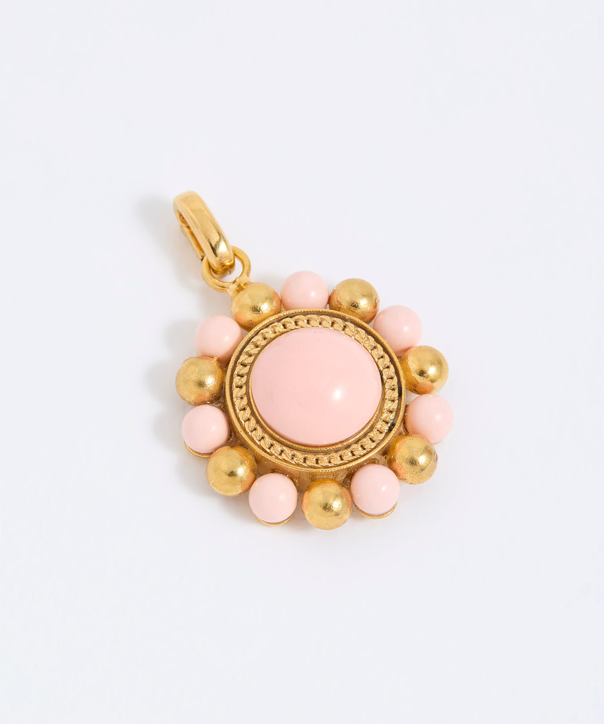 Gold coloured pendant with pink central stone and smaller pink stones on a white background