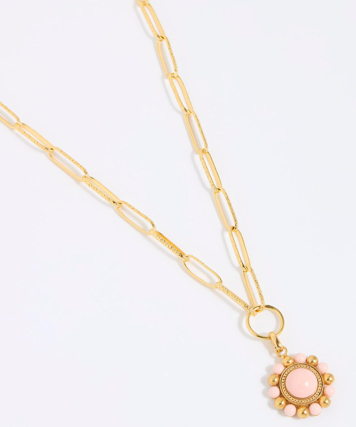Gold coloured chain necklace with a pink floral pendant on a white background