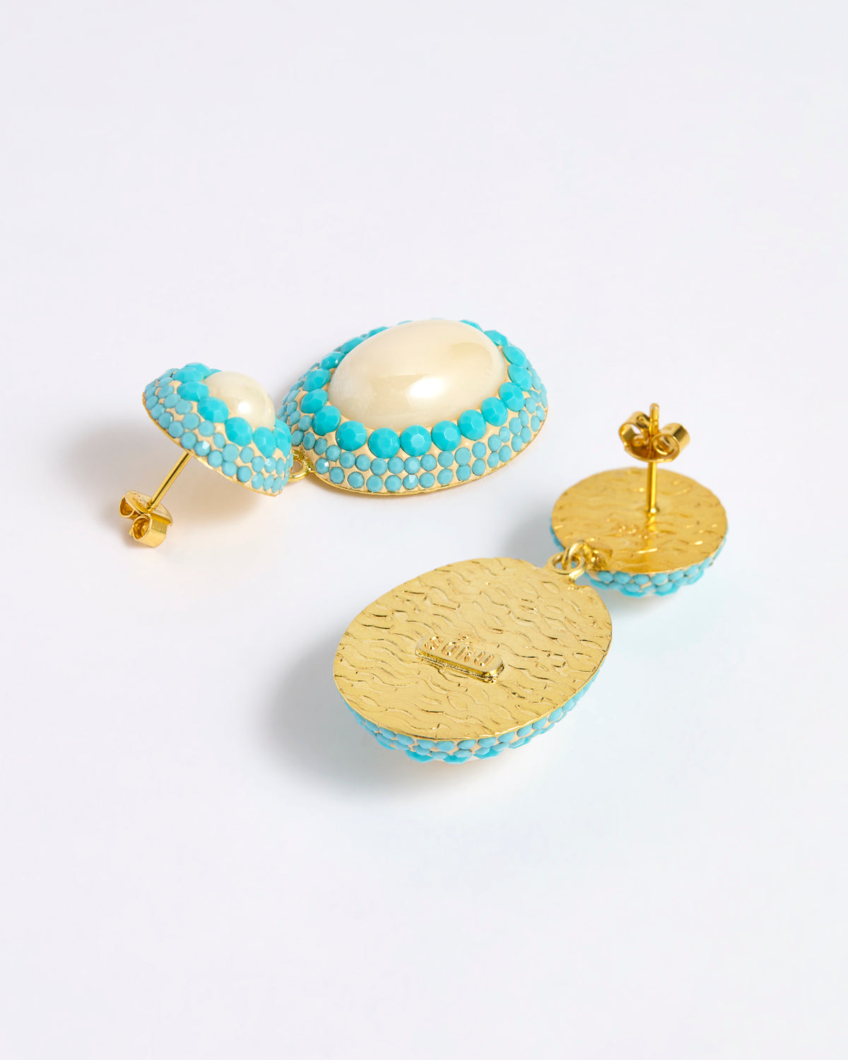 Reverse image of pearl drop earrings with three lines of turquoise coloured matt crystals as a border around the pearls and a gold plated smooth back with post for pierced ears.