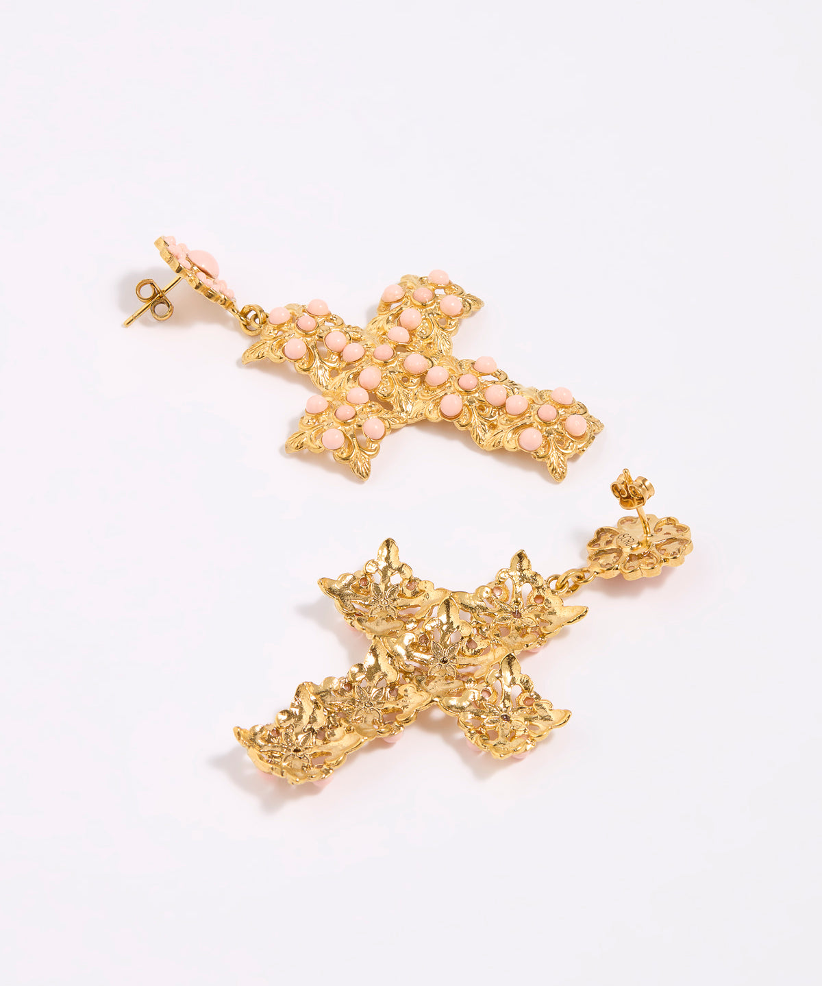 Gold cross-shaped earrings on a white background