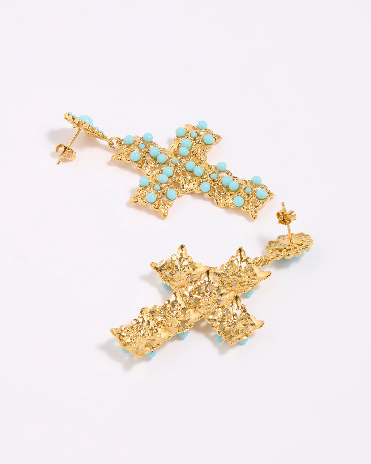 Gold cross-shaped earrings with turquoise stones on a white background