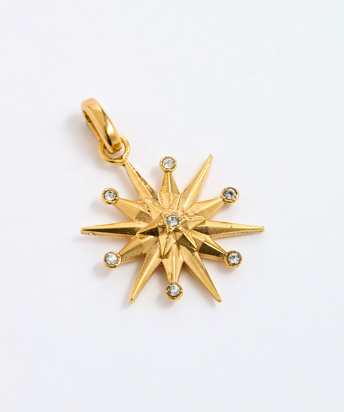 12-pointed star charm pendant featuring a central clear gemstone and six surrounding small round-cut stones, displayed on a white background.