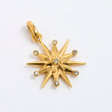 12-pointed star charm pendant featuring a central clear gemstone and six surrounding small round-cut stones, displayed on a white background.