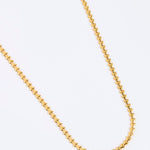 Gold chain of small hearts shown on white background