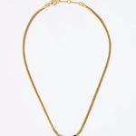 Gold necklace with a green and white fan shaped pendant on a white background