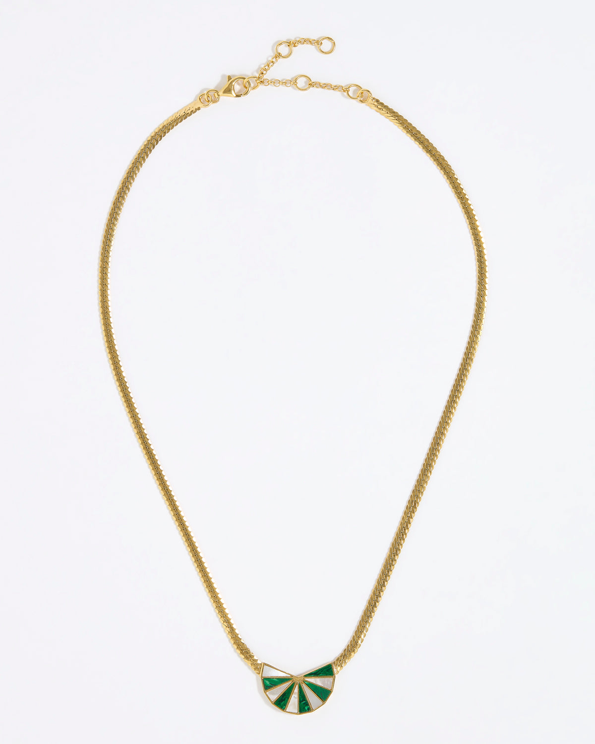 Gold necklace with a green and white fan shaped pendant on a white background