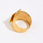 Gold ring with a unique design on a white background