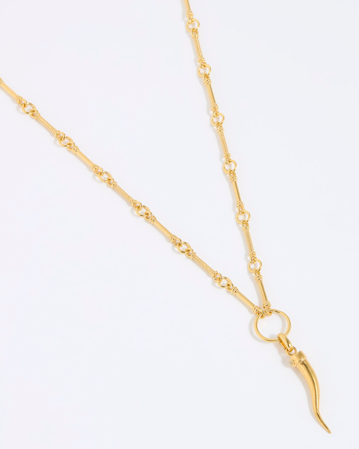 Gold necklace with cornicello charm pendant on a white background