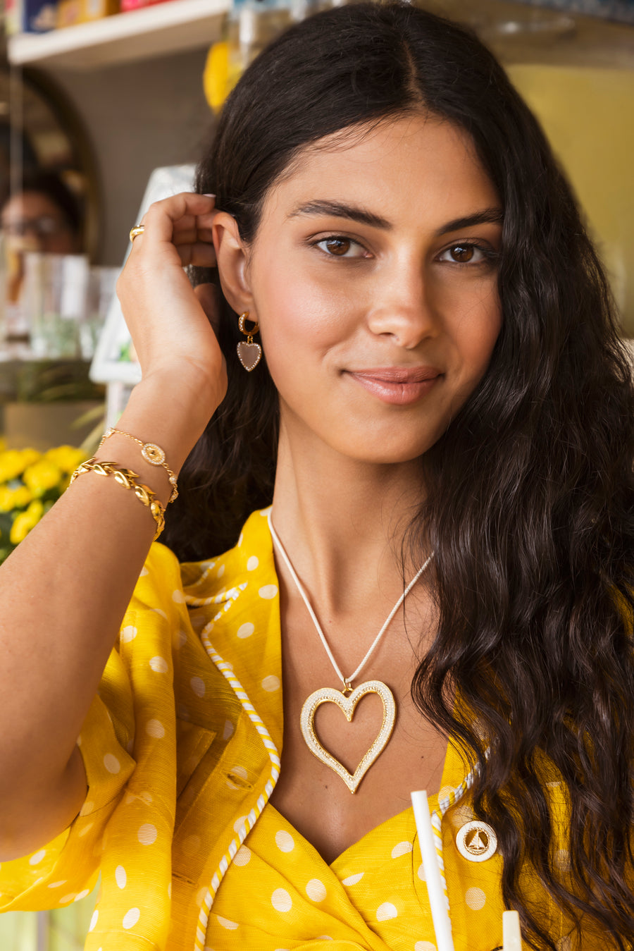 model shot of gold plated silver mother of pearl and crystal heart drop earrings