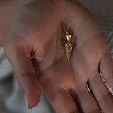 Lady holding gold pendant art deco charm 