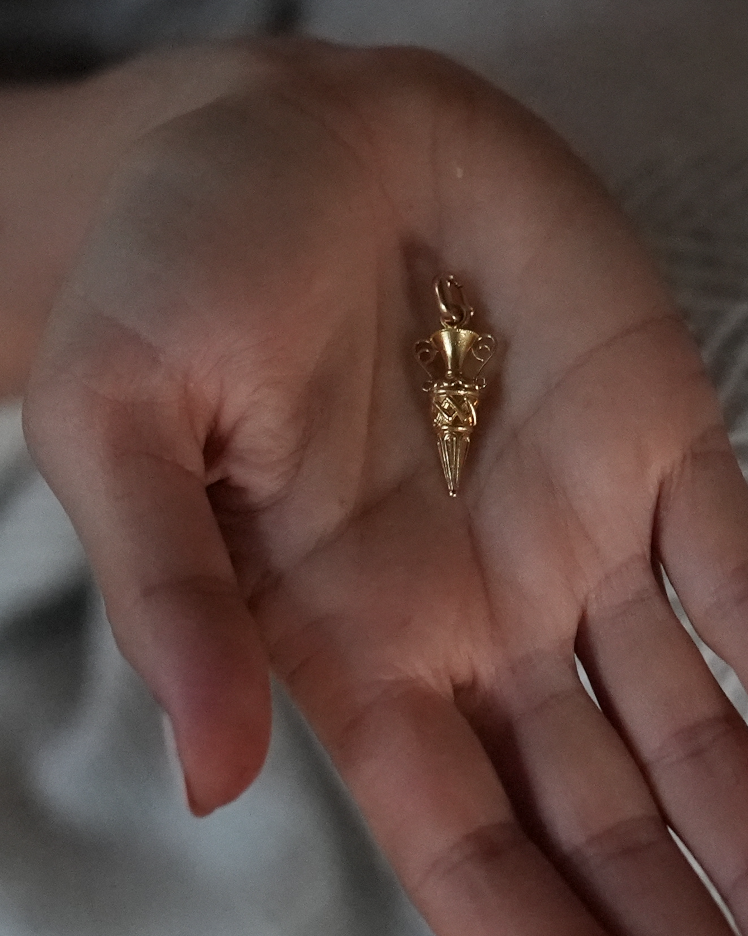 Lady holding gold pendant art deco charm 