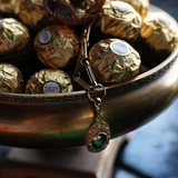 Pendant charm necklace on a bowl full of chocolates