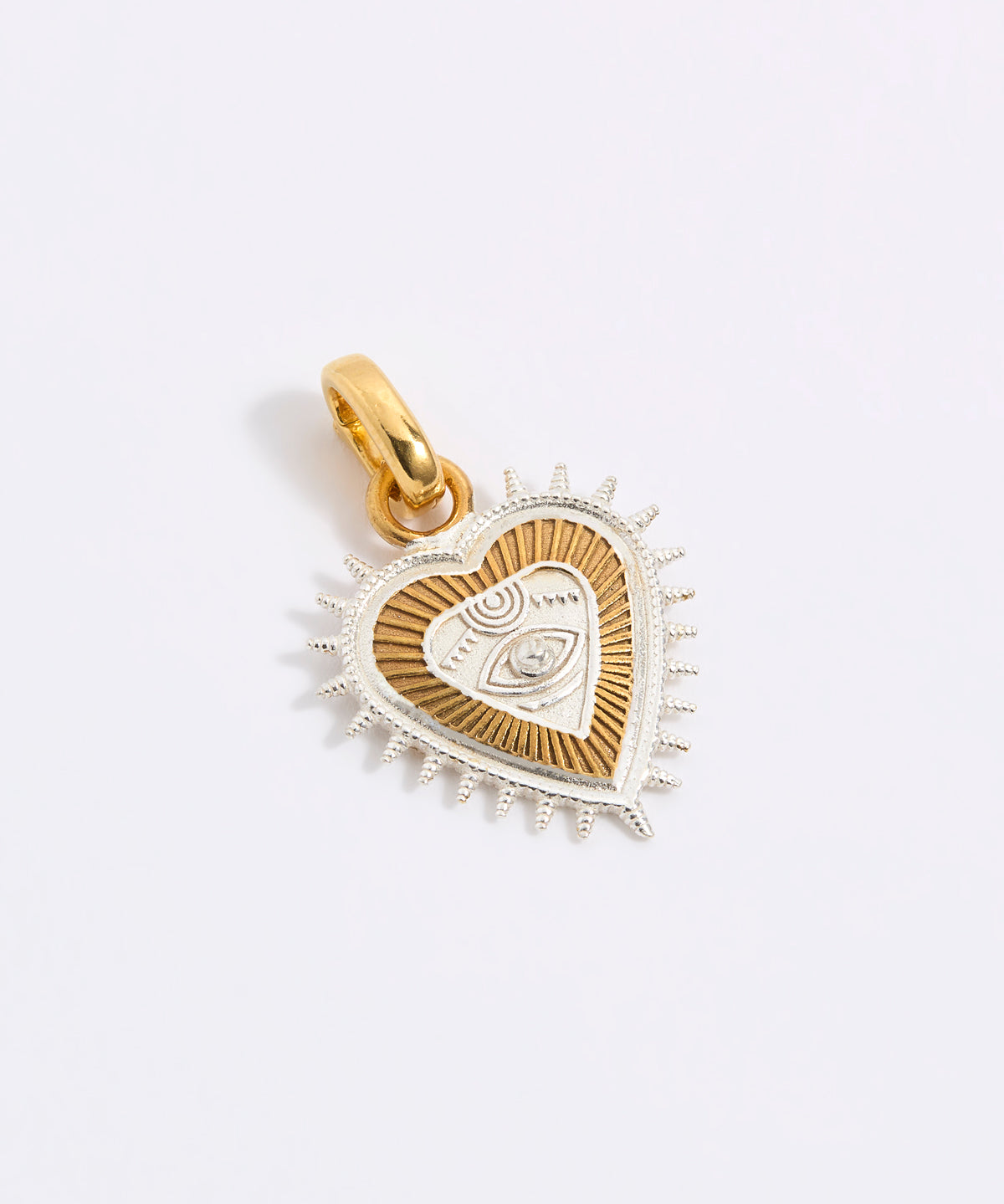 Gold and silver heart-shaped pendant on a light gray background