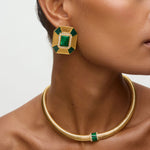 Close up side view of model shot wearing  statement gold and green malachite earrings with clear crystal embellished and matching necklace on a white background