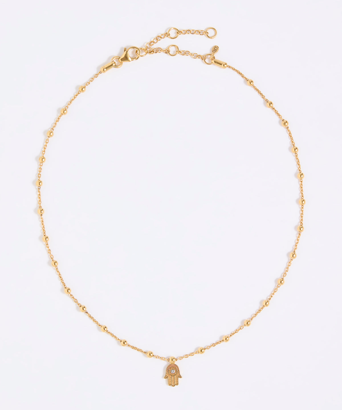 Gold coloured necklace with a hamsa hand pendant on a white background