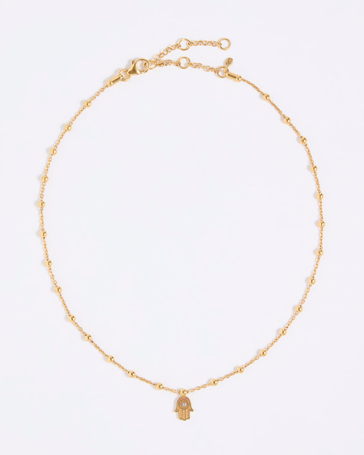 Gold coloured necklace with a hamsa hand pendant on a white background
