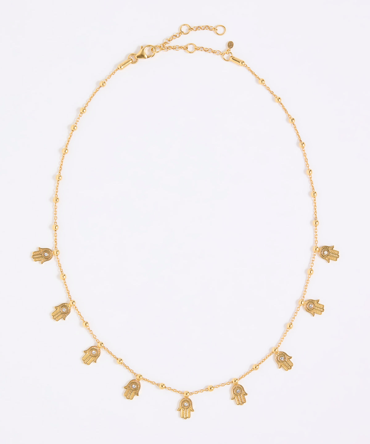 Gold coloured necklace with small hand-shaped charms on a white background