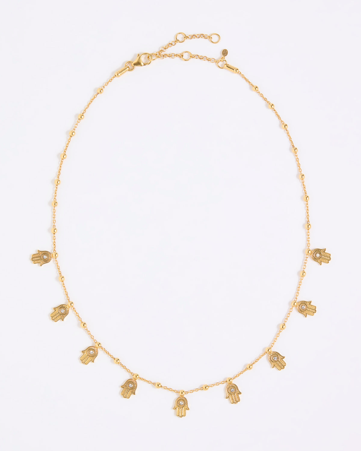 Gold coloured necklace with small hand-shaped charms on a white background