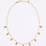 Gold coloured necklace with small hand-shaped charms on a white background